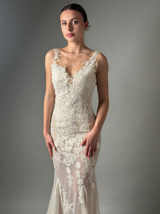 Elegant mermaid floral lace wedding dress with deep V neckline and open back, perfect for a modern bride.