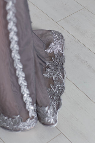 Silver strapless lace evening gown with sweetheart neckline and mermaid silhouette.