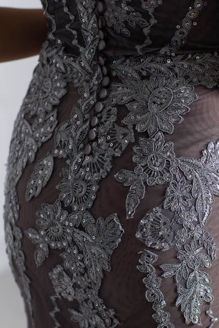 Silver strapless lace evening gown with sweetheart neckline and mermaid silhouette.